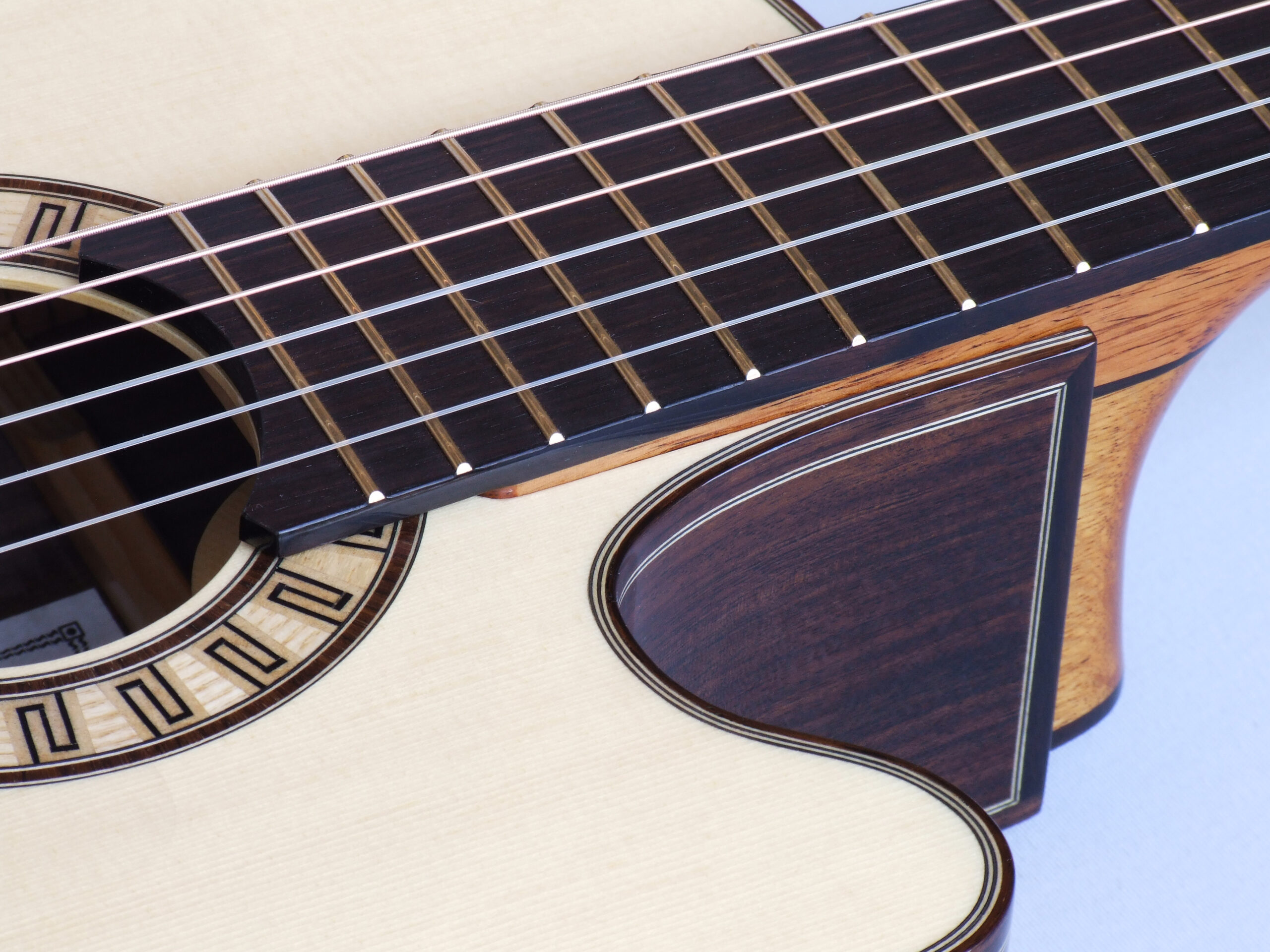 Custom guitars. Close-up of small body cutaway guitar with adjustable neck joint