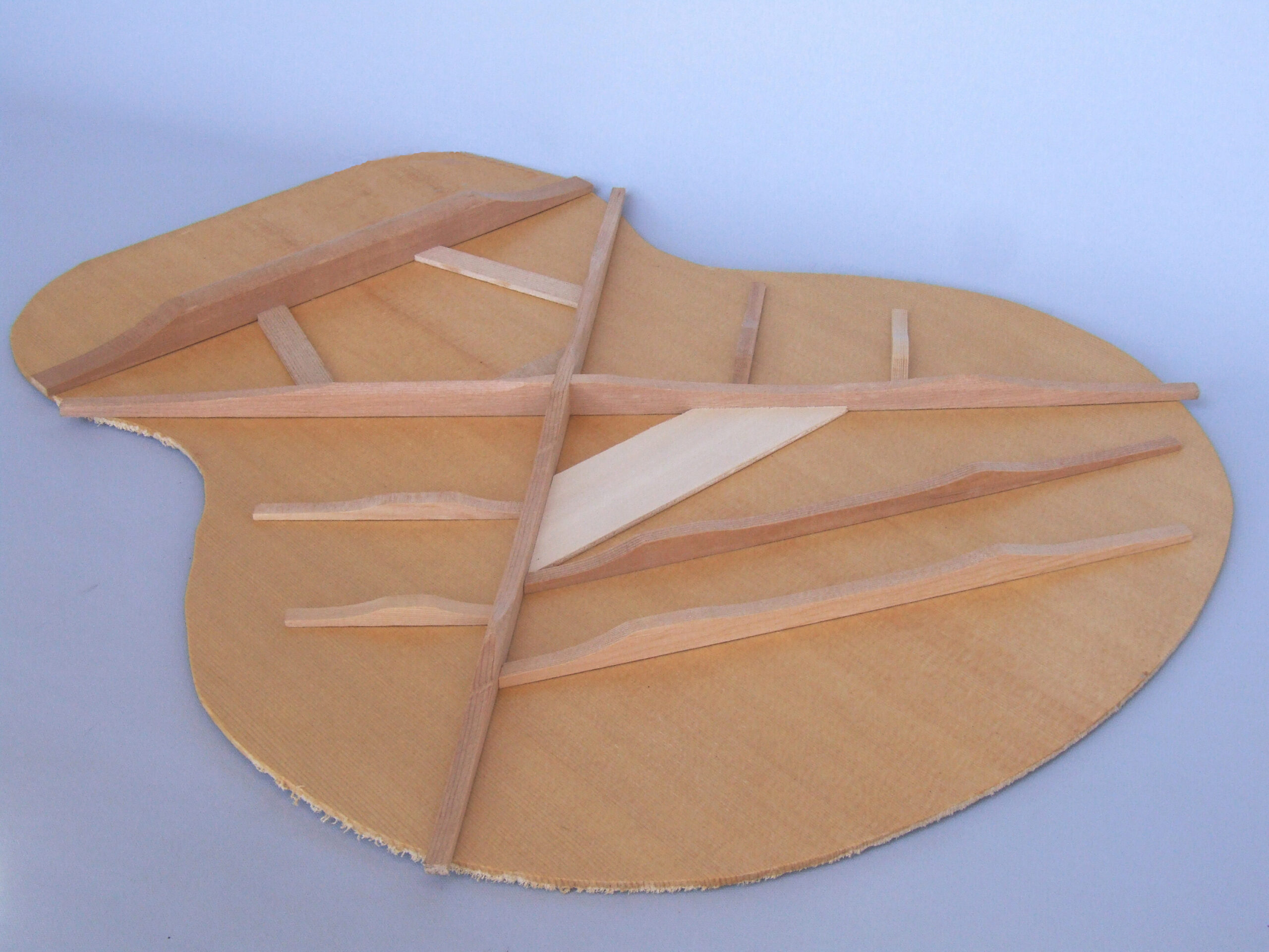 Custom guitars. Traditional X-bracing on the underside of a guitar top panel