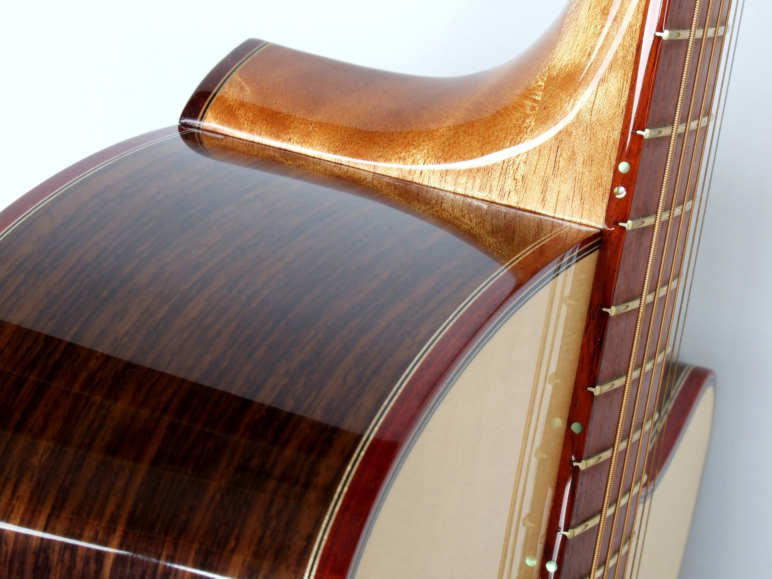 Detail of a neck joint on a steel string guitar