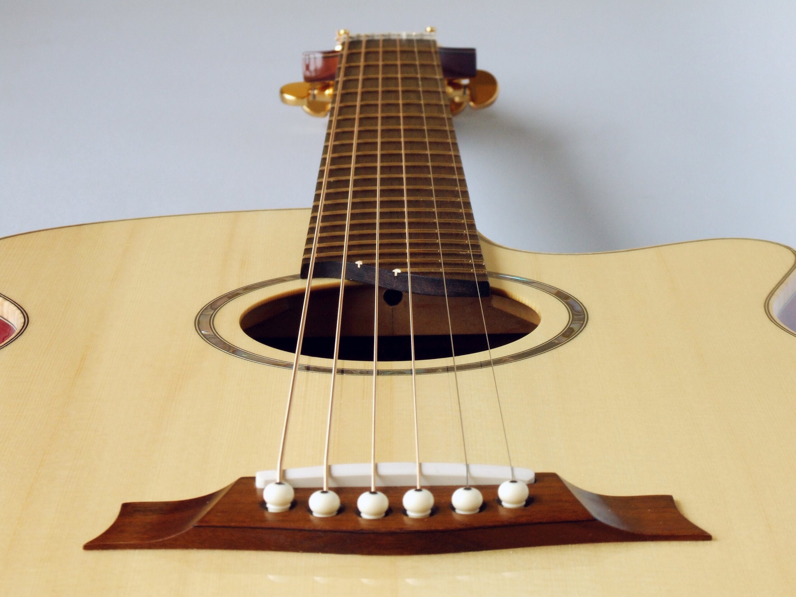 View from the bridge of a spruce top steel string guitar