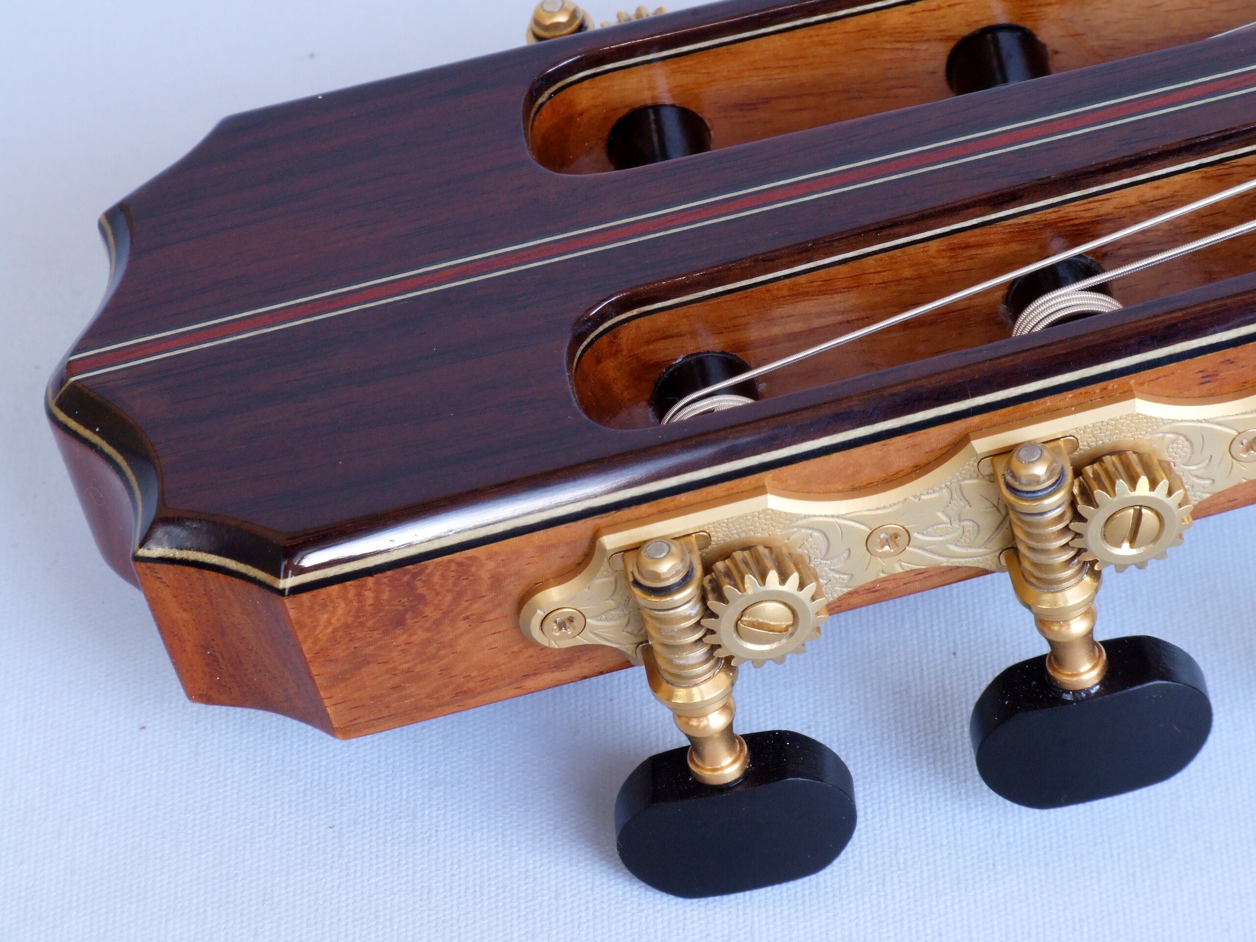 Detail of Gotoh tuners with ebony buttons on a classical guitar