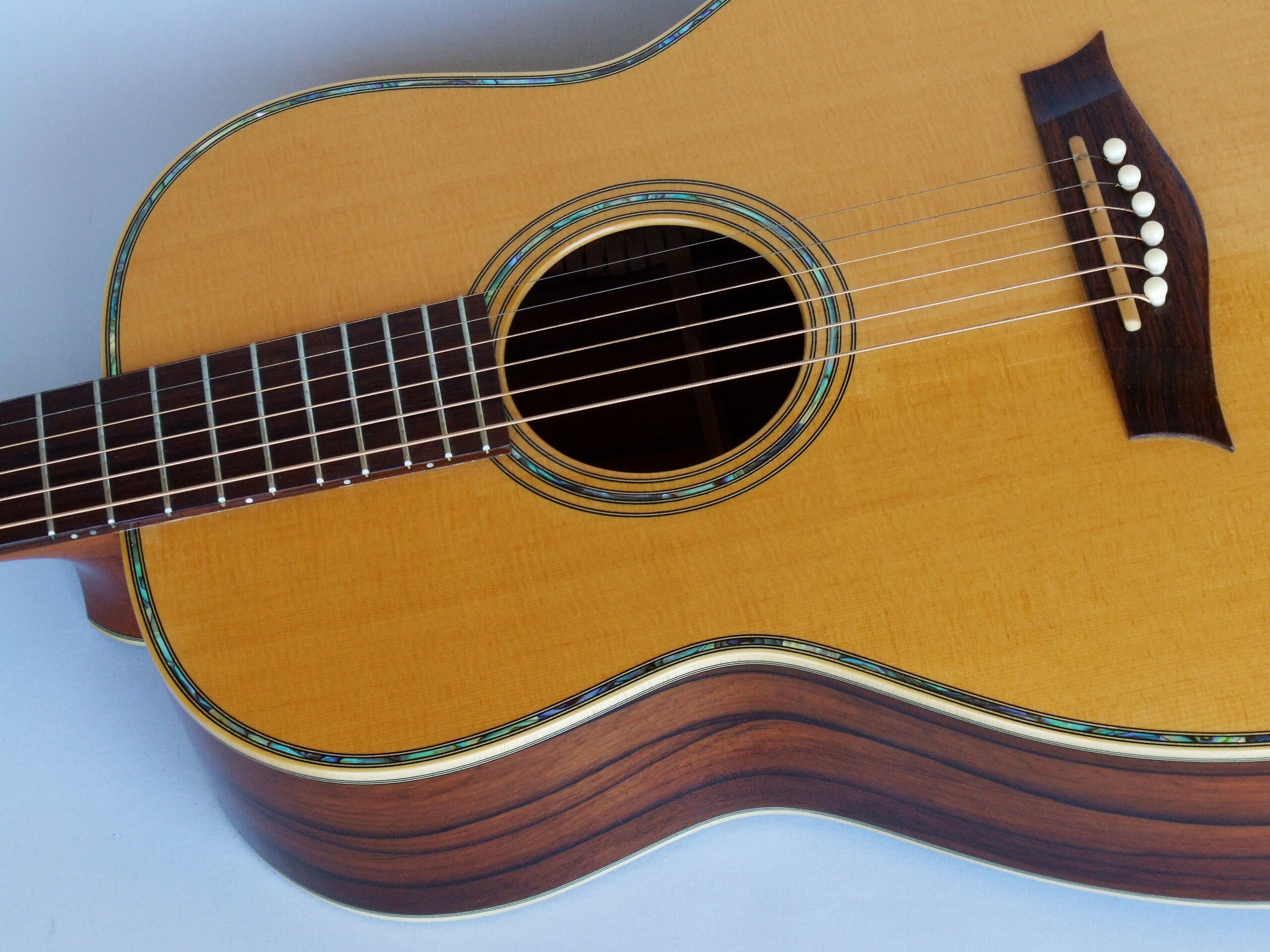 Custom guitars. Aged spruce top on a 12 fret 00 guitar with paua decoration