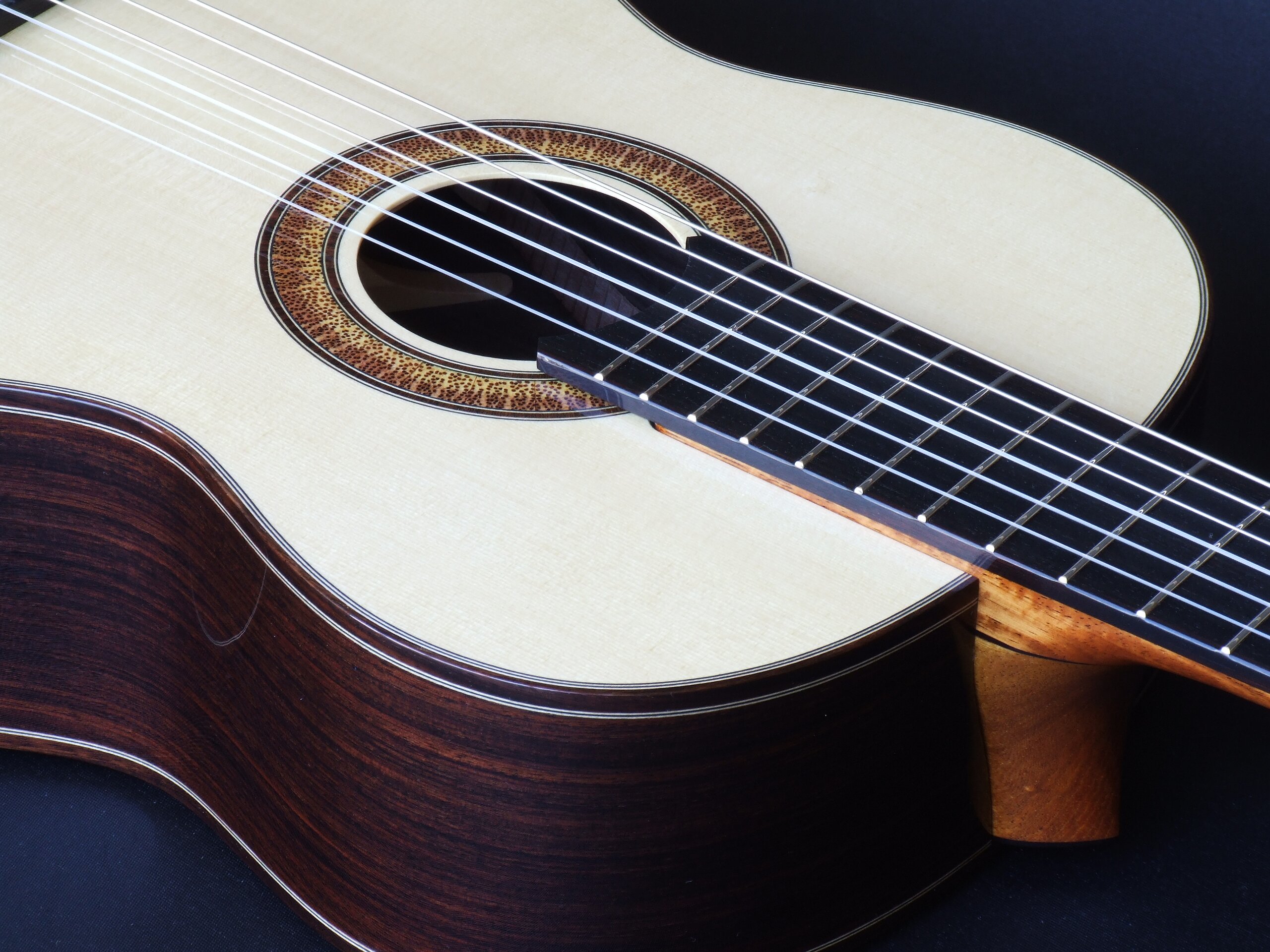 Custom guitars. Natural sunburst rosette and ebony fretboard on a classical guitar