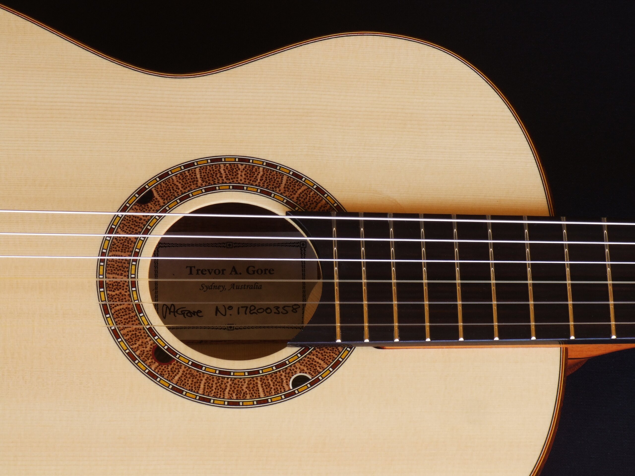 Custom guitars. Australiana rosette on a small body tilt neck classical guitar