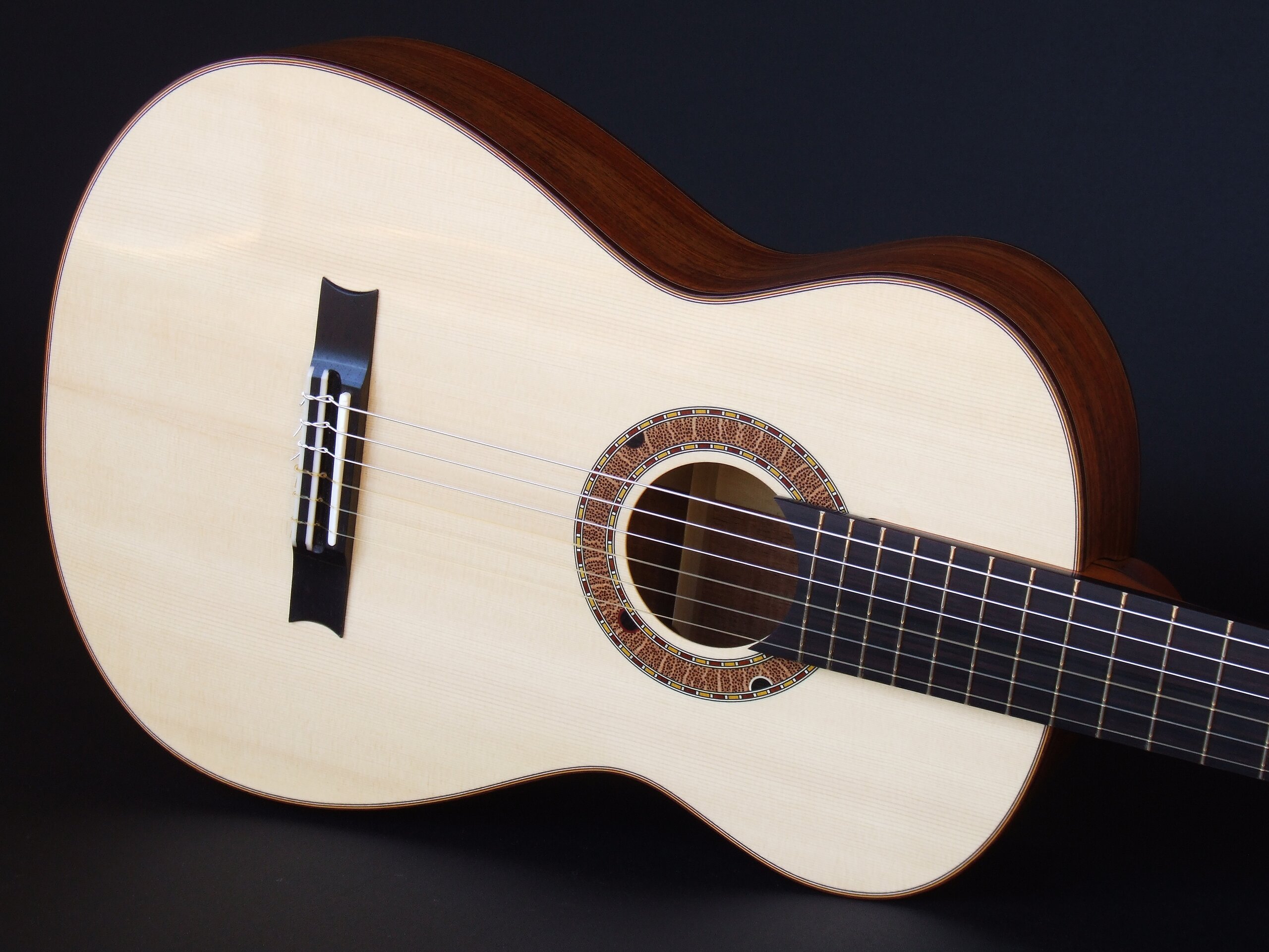 Custom guitars. Gore small body spruce topped classical guitar with Australiana rosette
