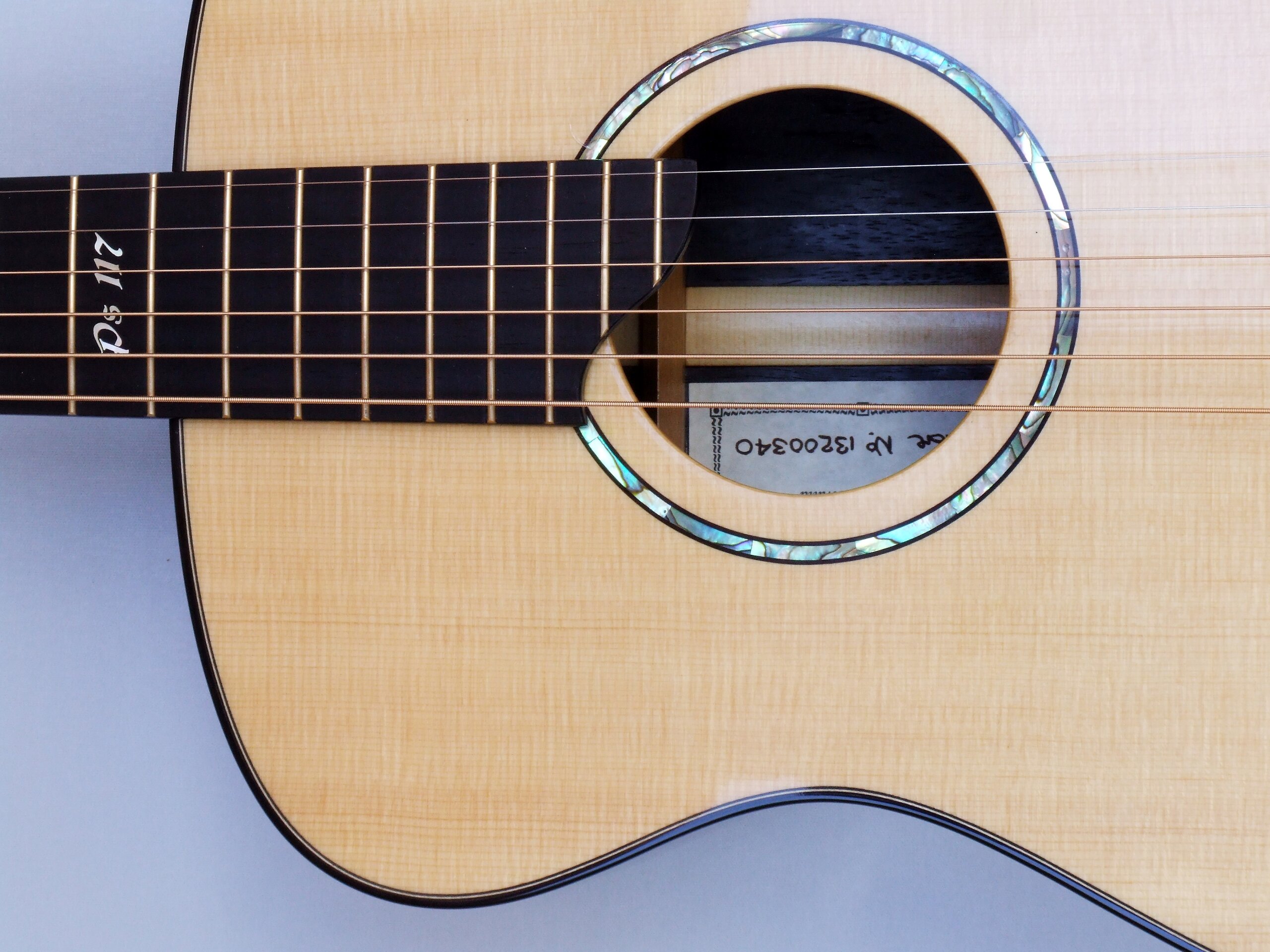 Custom guitars. Paua rosette in a Lutz spruce guitar top with fretboard inlay