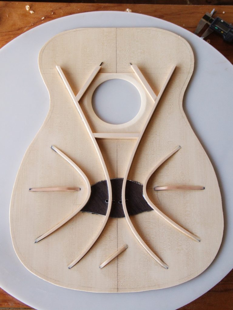 Incomplete falcate braced guitar top